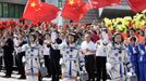 Chinese astronauts Jing Haipeng, Liu Wang (C) and Liu Yang (L), China's first female astronaut, wave during a departure ceremony at Jiuquan Satellite Launch Center, Gansu province, June 16, 2012. China will send its first woman into outer space this week, prompting a surge of national pride as the rising power takes its latest step towards putting a space station in orbit within the decade. Liu Yang, a 33-year-old fighter pilot, will join two other astronauts aboard the Shenzhou 9 spacecraft when it lifts off from a remote Gobi Desert launch site on Saturday evening. REUTERS/Jason Lee (CHINA - Tags: SCIENCE TECHNOLOGY) Published: Čer. 16, 2012, 8:13 dop.