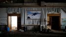 A poster of the snow-covered resort hangs on a wall at the abandoned Alps Ski Resort