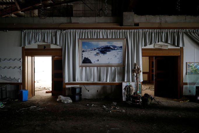 A poster of the snow-covered resort hangs on a wall at the abandoned Alps Ski Resort