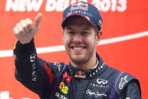 Red Bull Formula One driver Vettel celebrates on the podium after winning the Indian F1 Grand Prix at the Buddh International Circuit in Greater Noida
