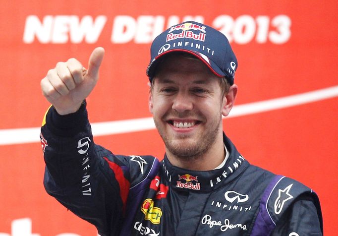 Red Bull Formula One driver Sebastian Vettel of Germany celebrates on the podium after winning the Indian F1 Grand Prix at the Buddh International Circuit in Greater Noid