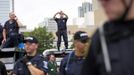 Police monitor a group of protesters outside the site of the Democratic National Convention in Charlotte, North Carolina, September 4, 2012. REUTERS/Philip Scott Andrews (UNITED STATES - Tags: CIVIL UNREST POLITICS ELECTIONS) Published: Zář. 4, 2012, 9:02 odp.