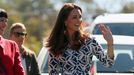 Catherine, Duchess of Cambridge, waves as she walks down a road in the Blue Mountains suburb of Winmalee, that lost homes during bushfires last year