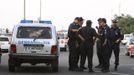 Police officers stand near a police vehicle after an explosion at Bulgaria's Burgas airport July 18, 2012. An explosion which killed six people and injured dozens of Israeli tourists at the Bulgarian airport of Burgas was caused by a bomb in their bus, Bulgarian Foreign Minister Nikolai Mladenov told Reuters by telephone. In a statement, the foreign ministry said five people were killed and one died later in hospital. Thirty two people were taken to hospital with injuries. REUTERS/Impact Press Group (BULGARIA - Tags: DISASTER TRANSPORT CRIME LAW)