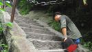 HUAYIN, CHINA - AUGUST 13: (CHINA OUT) Legless man Chen Zhou climbs the Huashan Mountain on August 13, 2012 in Huayin, Shaanxi Province of China. Legless 29-year-old man Chen Zhou from Cangshan of Shandong Province spent two days, 19 hours in total, climbing by arms to the top of Huashan Mountain. Chen lost his legs after falling off a train at the age of 13, but he has since strived to be stronger and joined in many public performances to encourage other people. Chen Zhou will climb the Taishan Mountain in Shandong province in the following months. ( automatický překlad do češtiny )