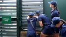 Tennis - Wimbledon - All England Lawn Tennis and Croquet Club, London, Britain - July 3, 2019  General view of a ball boy and ball girls peering through the slats of a ga