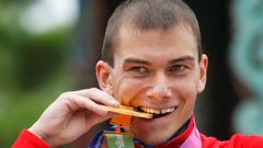 FILE PHOTO: Bakulin of Russia bites his gold medal after the men's 50 km race walk final at the IAAF World Athletics Championships in Daegu
