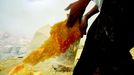 Sulfur Miners Of Ijen Crater Indonesia BANYUWANGI, INDONESIA - UNDATED: A miner lifts sulfur at a mine in the crater of Ijen, Banyuwangi, Indonesia. Sulphur miners at the