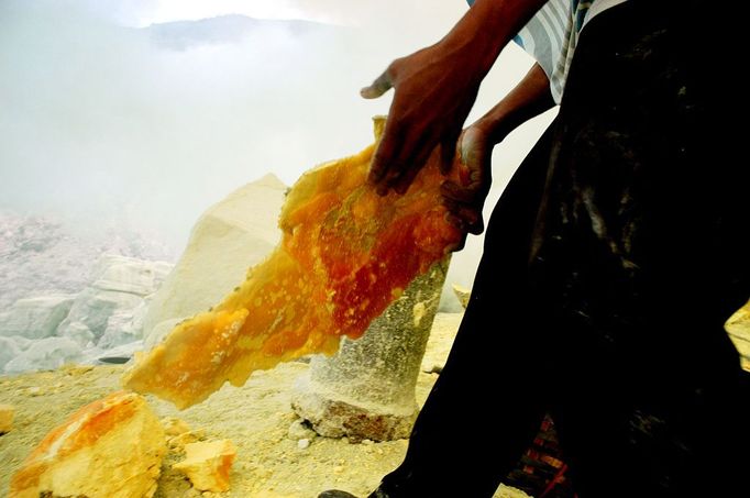 Sulfur Miners Of Ijen Crater Indonesia BANYUWANGI, INDONESIA - UNDATED: A miner lifts sulfur at a mine in the crater of Ijen, Banyuwangi, Indonesia. Sulphur miners at the