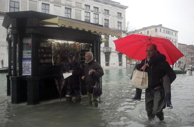 People walk in a flooded street during a period of seasonal high water in Venice November 1, 2012. The water level in the canal city rose to about 140cm (55 inches) above normal, according to the monitoring institute. REUTERS/Manuel Silvestri (ITALY - Tags: ENVIRONMENT SOCIETY) Published: Lis. 1, 2012, 12:53 odp.