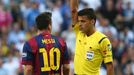 Barcelona's Lionel Messi (L) is shown a yellow card by referee Gil Manzano during the Spanish first division &quot;Clasico&quot; soccer match against Real Madrid at the S