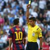Barcelona's Messi is shown a yellow card by referee Manzano during the Spanish first division &quot;Clasico&quot; soccer match against Real Madrid at the Santiago Bernabeu stadium in Madrid