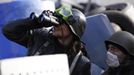 An anti-government protester looks through binoculars as he mans a barricade in Kiev February 21, 2014.