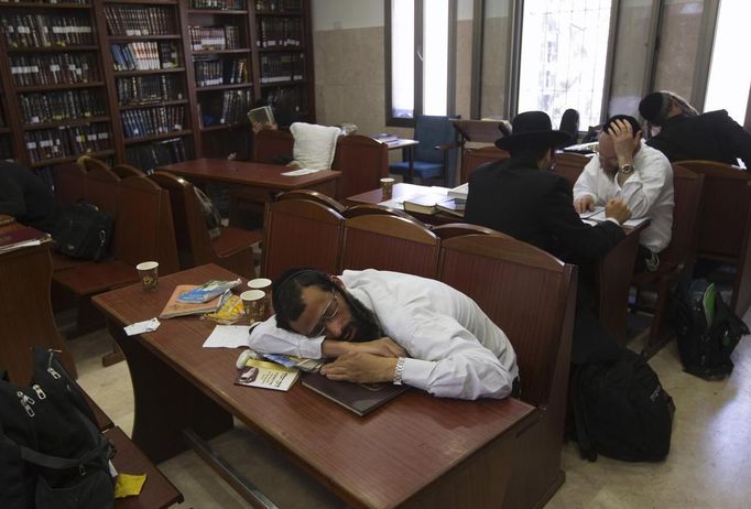 An ultra-Orthodox Jewish man sleeps as others study at a Yeshiva, a Jewish seminary, in Jerusalem's Mea Shearim neighbourhood May 24, 2012. The ultra-Orthodox Jews have gone from being a tiny minority in Israel's mostly secular society to its fastest-growing sector, now about 10 percent of the 7.8 million population. They are exempt from military duty in Israel but draft deferments and state subsidies for the ultra-Orthodox have become a divisive political issue in Israel, where the government must decide a new law by August to ensure more of them do military service. Picture taken May 24, 2012. REUTERS/Ronen Zvulun (JERUSALEM - Tags: RELIGION POLITICS MILITARY EDUCATION) ATTENTION EDITORS - PICTURE 21 OF 21 FOR PACKAGE "ISRAEL'S ULTRA-ORTHODOX". SEARCH "ULTRA-ORTHODOX" FOR ALL PICTURES