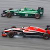 Marussia Formula One driver Bianchi passes Caterham Formula One driver Ericsson during the first practice session of the Malaysian F1 Grand Prix at Sepang International Circuit outside Kuala Lumpur