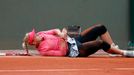 Sabine Lisicki of Germany holds her arm after falling during her women's singles match against compatriot Mona Barthel at the French Open tennis tournament at the Roland