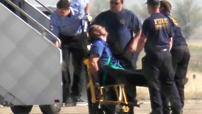 Policisté a zaměstnanci letiště v texaském Amarillu vyvádějí spoutaného kapitána Claytona Fredericka Osbona z letadla.