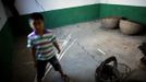 A boy stands inside a cracked house after a landslide near Badong, on the banks of the Yangtze River, 100km (62 miles) from the Three Gorges dam in Hubei province August 7, 2012. China relocated 1.3 million people during the 17 years it took to complete the Three Gorges dam. Even after finishing the $59 billion project last month, the threat of landslides along the dam's banks will force tens of thousands to move again. It's a reminder of the social and environmental challenges that have dogged the world's largest hydroelectric project. While there has been little protest among residents who will be relocated a second time, the environmental fallout over other big investments in China has become a hot-button issue ahead of a leadership transition this year. Picture taken on August 7, 2012. To match story CHINA-THREEGORGES/ REUTERS/Carlos Barria (CHINA - Tags: POLITICS ENVIRONMENT BUSINESS ENERGY) Published: Srp. 22, 2012, 8:15 odp.