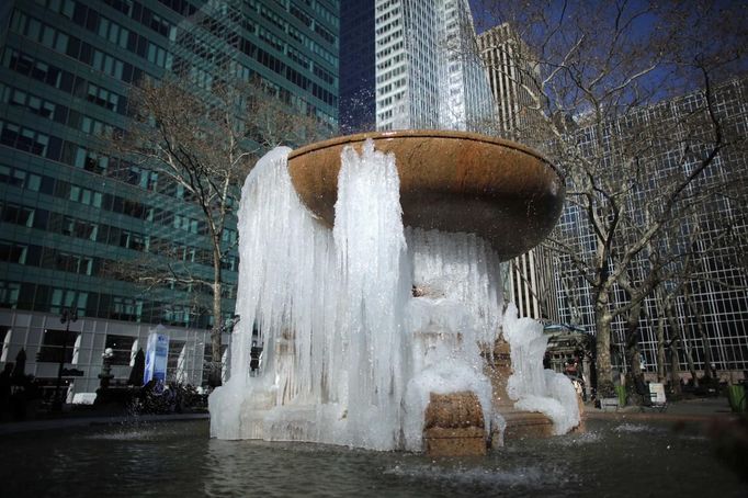 A fountain partially frozen into ice is seen at Bryant Park in New York, January 24, 2013. Frigid arctic air held the U.S. Midwest and Northeast in its icy grip on Wednesday, with the cold so dangerous that municipal emergency warming centers opened up and ski resorts shut down. Wintry conditions from Minneapolis to Washington marked the coldest conditions in many parts of the United States in four years, but were nowhere near the record lows for January, meteorologists said. REUTERS/Eduardo Munoz (UNITED STATES - Tags: ENVIRONMENT SOCIETY) Published: Led. 24, 2013, 7:32 odp.