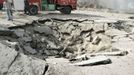 A Syrian security official stands near a crater at the site of an explosion in Damascus May 10, 2012. Dozens of people were killed or wounded in two "terrorist explosions" which struck a southern district of the Syrian capital Damascus on Thursday, state television said. REUTERS/Sana/Handout (SYRIA - Tags: CIVIL UNREST POLITICS) FOR EDITORIAL USE ONLY. NOT FOR SALE FOR MARKETING OR ADVERTISING CAMPAIGNS. THIS IMAGE HAS BEEN SUPPLIED BY A THIRD PARTY. IT IS DISTRIBUTED, EXACTLY AS RECEIVED BY REUTERS, AS A SERVICE TO CLIENTS Published: Kvě. 10, 2012, 7:07 dop.