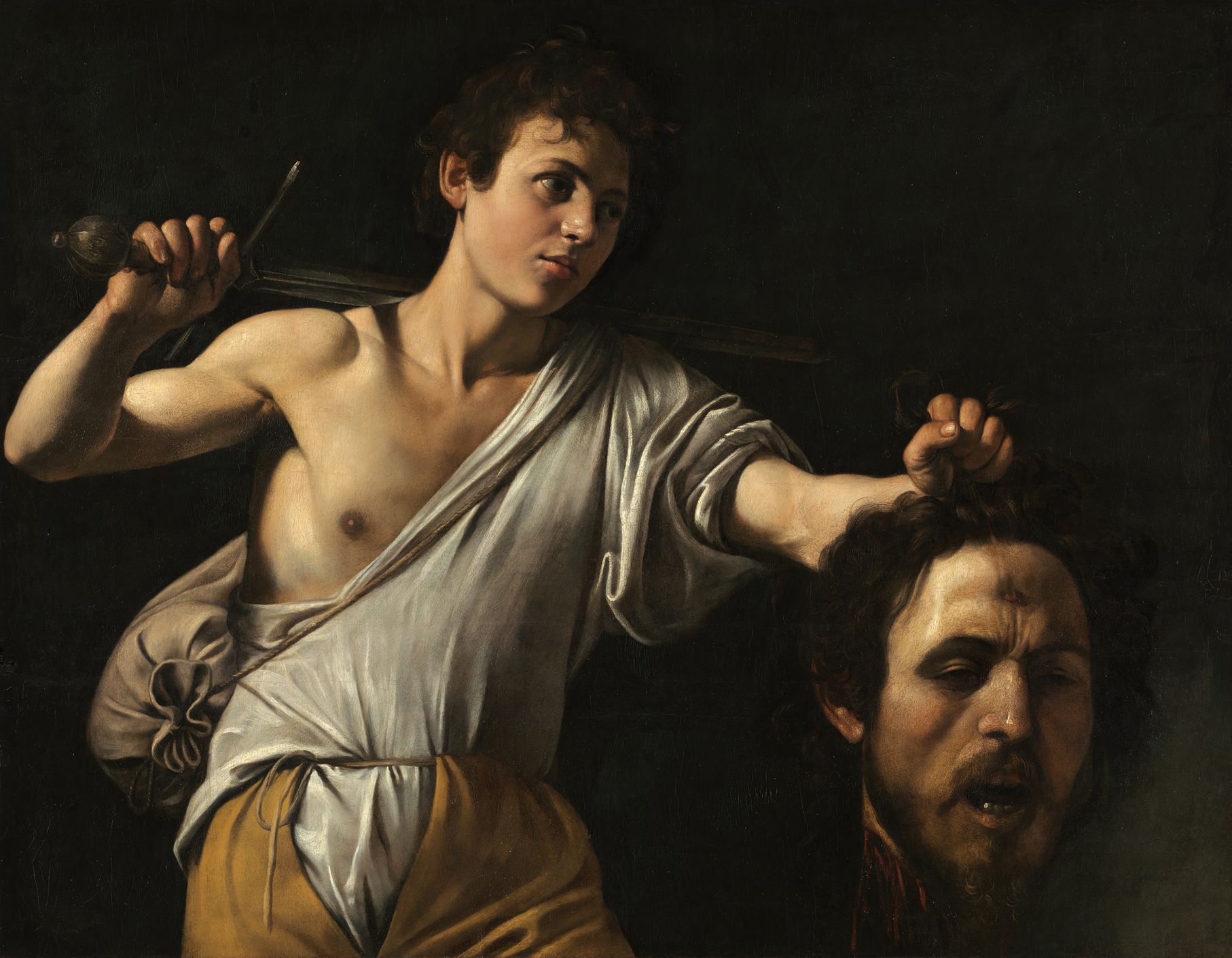 Caravaggio: David s hlavou Goliáše
