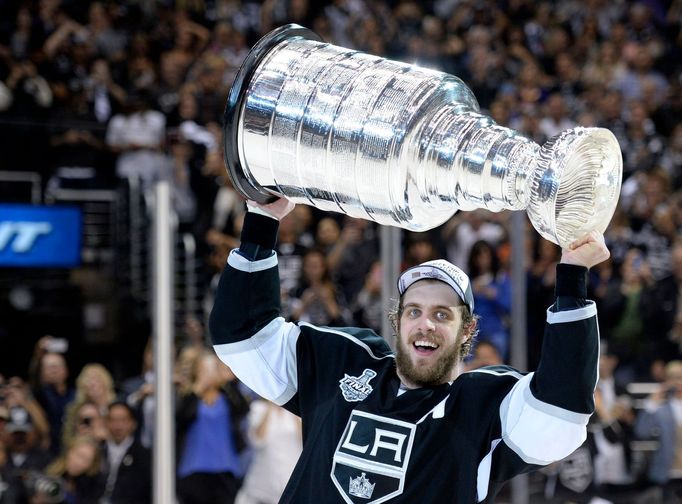 Jun 13, 2014; Los Angeles, CA, USA; Los Angeles Kings center Anze Kopitar (11) hoists the Stanley Cup after defeating the New York Rangers in game five of the 2014 Stanle