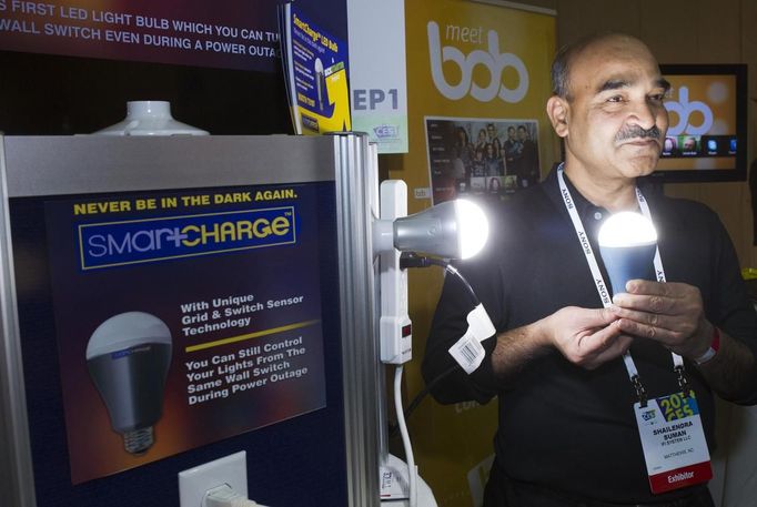 Founder Shailendra Suman poses with a SmartCharge LED lightbulb during &quot;CES Unveiled,&quot; a media preview event to the annual Consumer Electronics Show (CES), in L