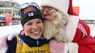 Second-placed Krista Parmakoski of Finland gets a kiss from a man dressed as Santa Claus after ladies' Cross Country 10 km Classic at FIS Ruka Nordic 2016 World Cup sea