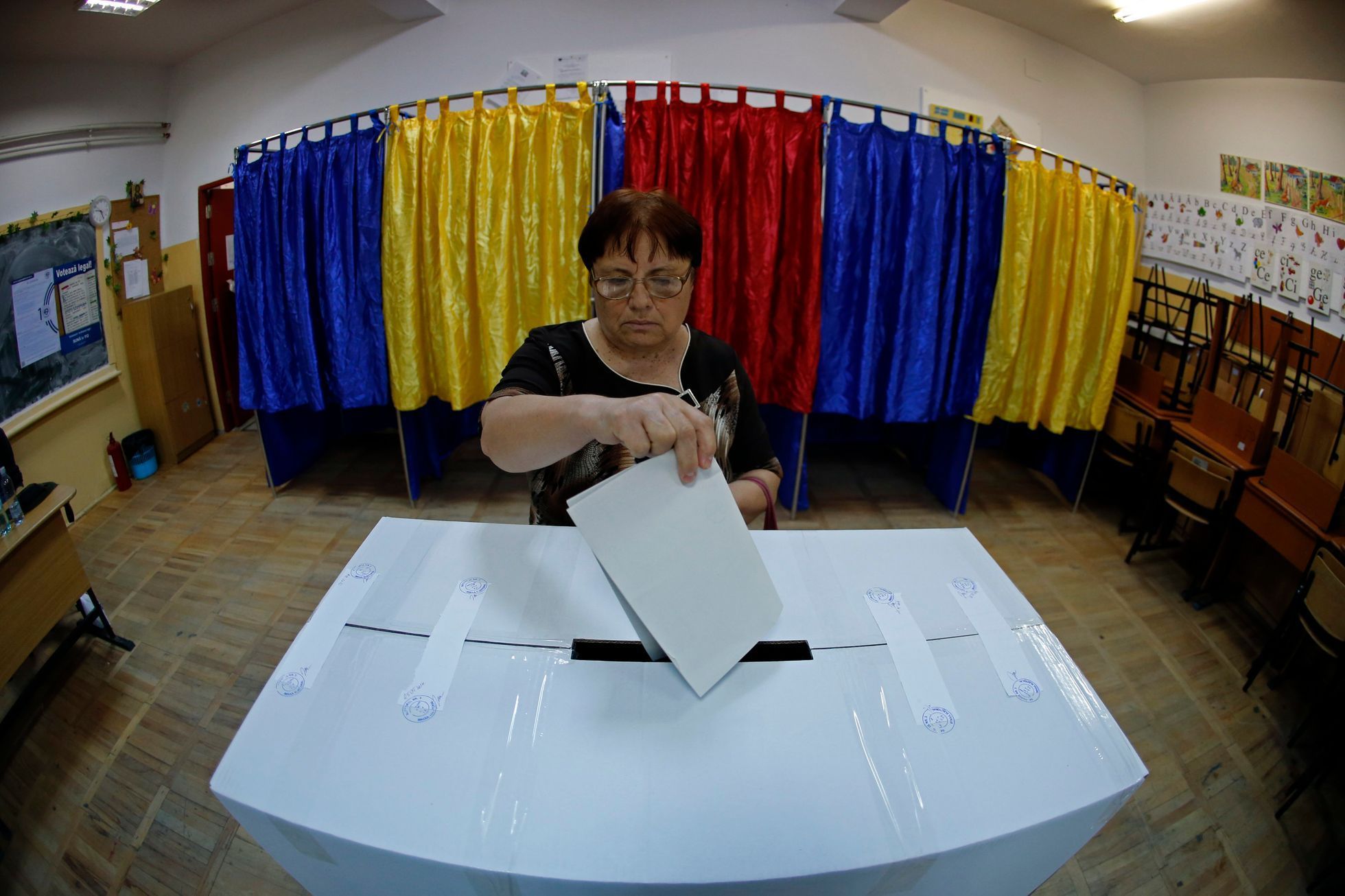 A woman casts her vote at a polling station in Bucharest