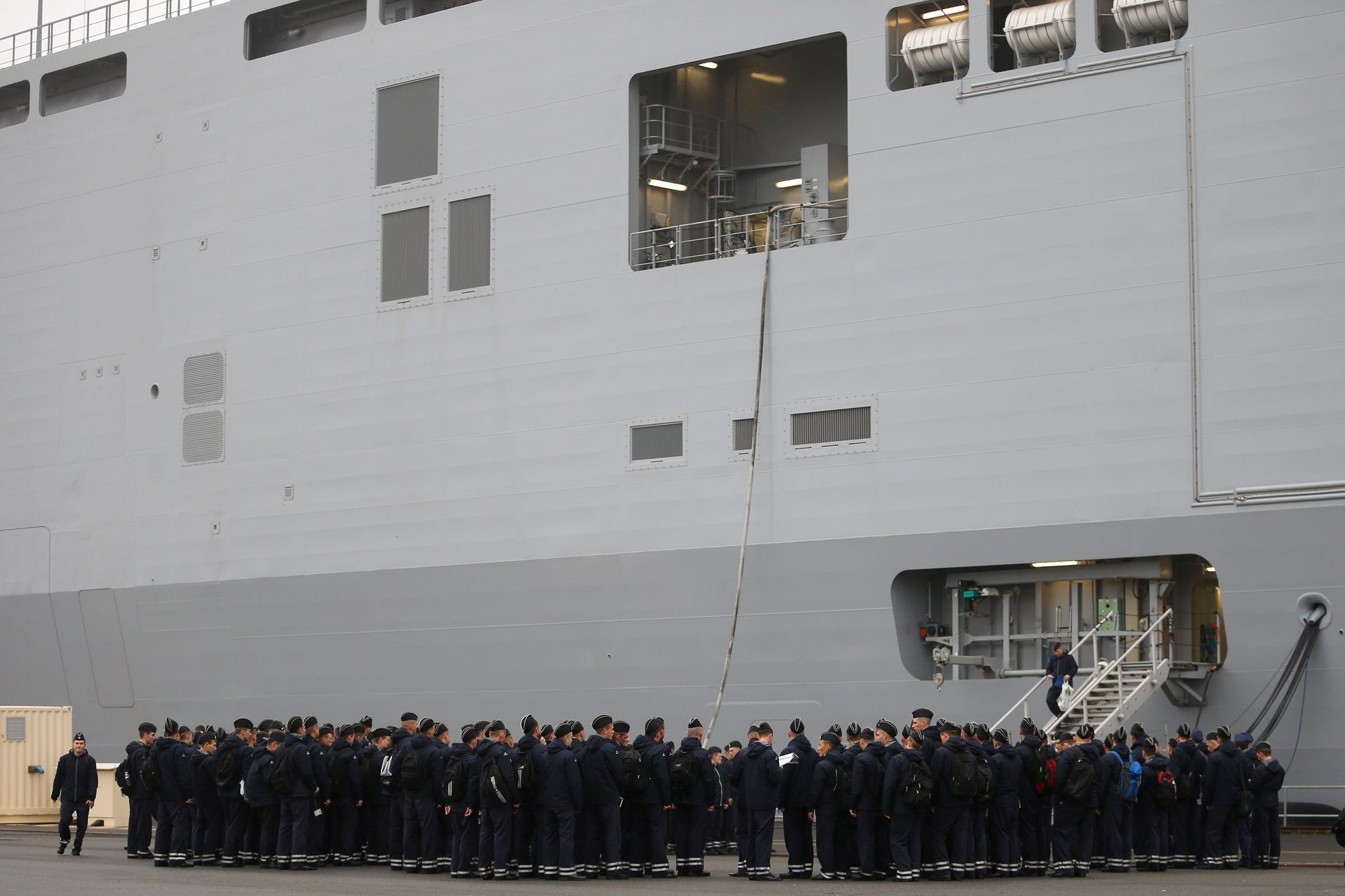 Russian sailors gather in front of the Mistral-class helicopter carrier Vladivostok at the STX Les Chantiers de l'Atlantique shipyard site in Saint-Nazaire