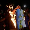 Demonstrators burn a 2014 World Cup sticker album during a protest against the 2014 World Cup in Rio de Janeiro
