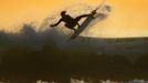 RNPS IMAGES OF THE YEAR 2012 - A young surfer sails his board off a wave as large swells hit the California coastline at dusk in Cardiff, California, January 5, 2012. REUTERS/Mike Blake (UNITED STATES - Tags: SOCIETY ENVIRONMENT SPORT TPX IMAGES OF THE DAY) Published: Pro. 5, 2012, 10:55 odp