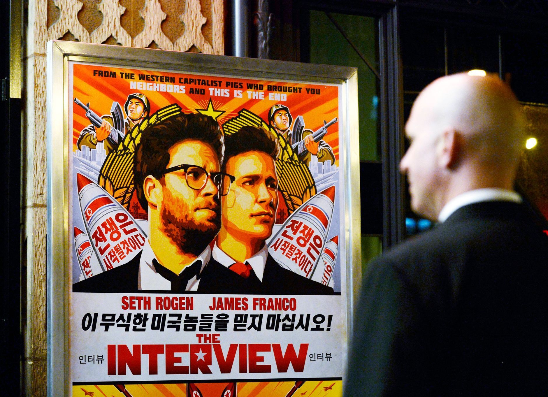 File photo of a security guard standing at the entrance of United Artists theater during the premiere of the film &quot;The Interview&quot; in Los Angeles