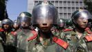 Riot policemen stand guard outside the Japanese embassy during a protest in Beijing September 15, 2012. Thousands of protesters besieged the Japanese embassy in Beijing on Saturday, hurling rocks and bottles at the building as police struggled to keep control, amid growing tensions between Asia's two biggest economies over a group of disputed islands. REUTERS/Jason Lee (CHINA - Tags: CIVIL UNREST POLITICS TPX IMAGES OF THE DAY)