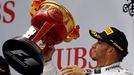 Mercedes Formula One driver Lewis Hamilton of Britain waves his trophy on the winners' podium, after winning the Chinese F1 Grand Prix at the Shanghai International circu