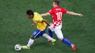 Brazil's Paulinho (L) fights for the ball with Croatia's Luka Modric during the 2014 World Cup opening match between Brazil and Croatia at the Corinthians arena in Sao Pa