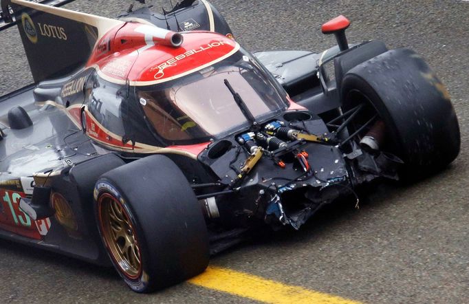 Andrea Belicchi of Italy arrives at the pit lane in his Lola B12/60 Coupe Toyota number 13 after a crash during the Le Mans 24-hour sportscar race in Le Mans, central Fra