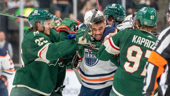 Apr 12, 2022; Saint Paul, Minnesota, USA; Minnesota Wild defenseman Jonas Brodin (25) and left wing Kirill Kaprizov (97) tangle with Edmonton Oilers left wing Evander Kan