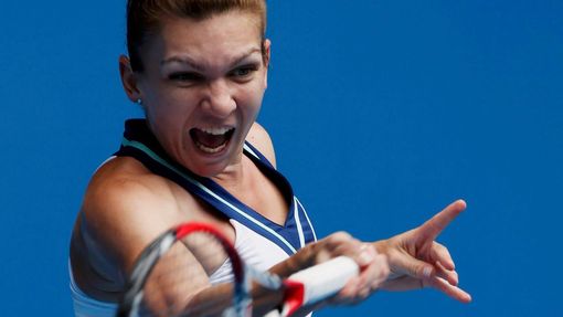 Simona Halep of Romania hits a return to Jelena Jankovic of Serbia during their women's singles match at the Australian Open 2014 tennis tournament in Melbourne