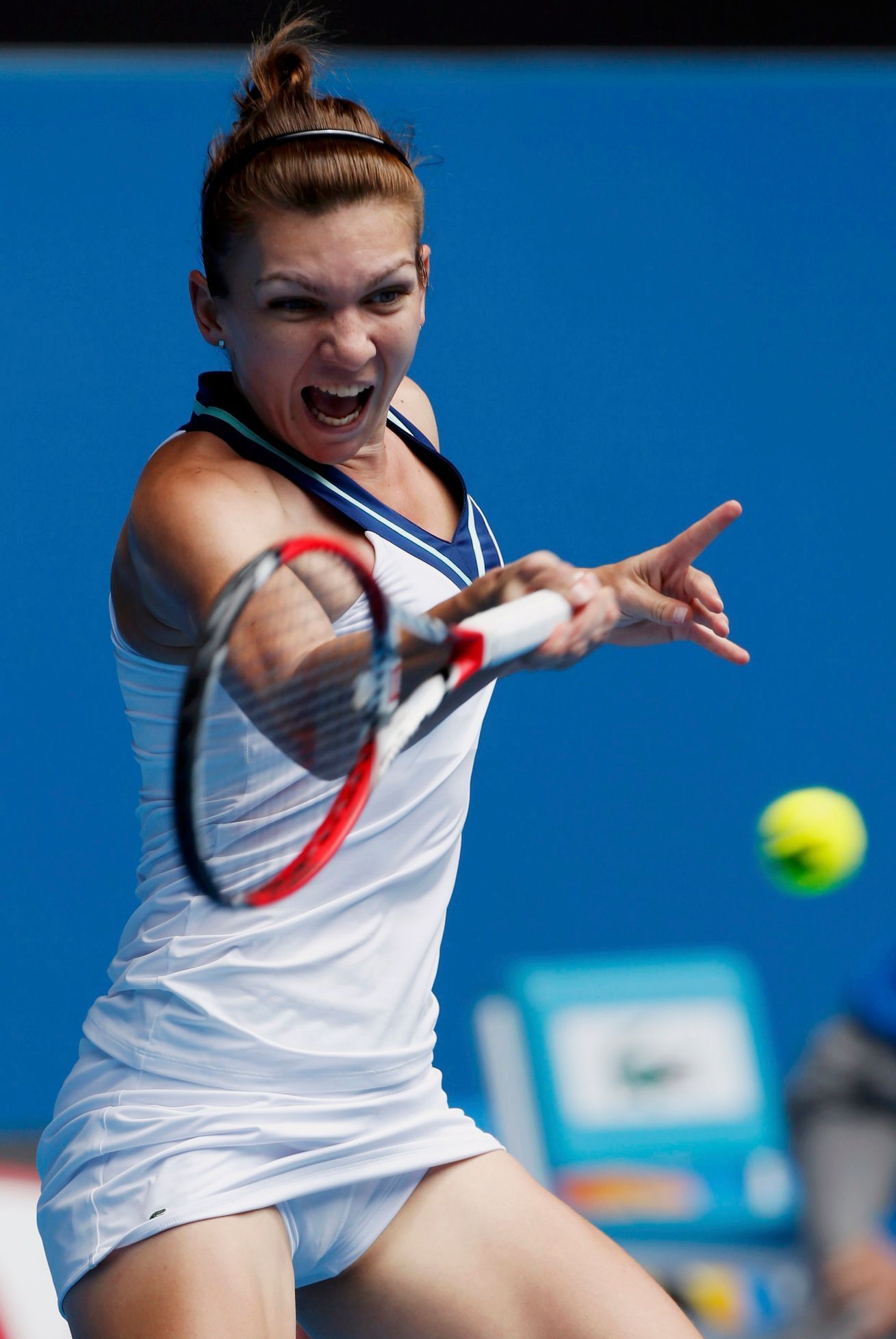 Simona Halep of Romania hits a return to Jelena Jankovic of Serbia during their women's singles match at the Australian Open 2014 tennis tournament in Melbourne