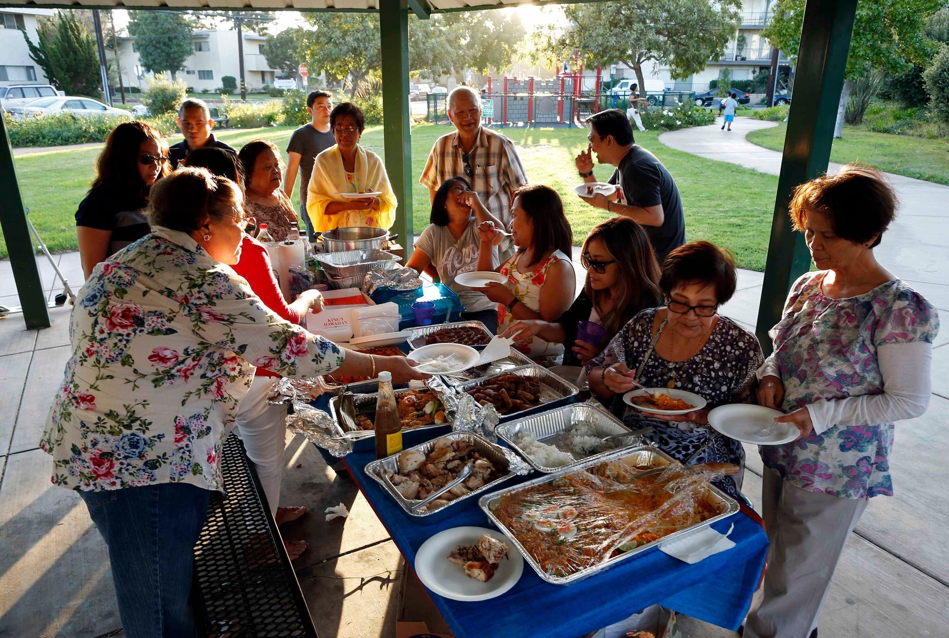 Retired professor Carlos Jainga and his wife Estrella Jainga attend a farewell party for Dolores Saballo, a friend returning to the Philippines, at a park in Torrance