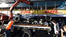 The car of McLaren Formula One driver Kevin Magnussen of Denmark is returned to the pit after he crashed during the second practice session of the Australian F1 Grand Pri