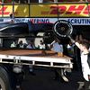 The car of McLaren Formula One driver Kevin Magnussen of Denmark is returned to the pit after he crashed during the second practice session of the Australian F1 Grand Prix at the Albert Park circuit i