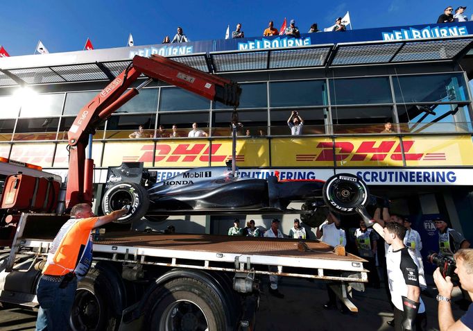 The car of McLaren Formula One driver Kevin Magnussen of Denmark is returned to the pit after he crashed during the second practice session of the Australian F1 Grand Pri