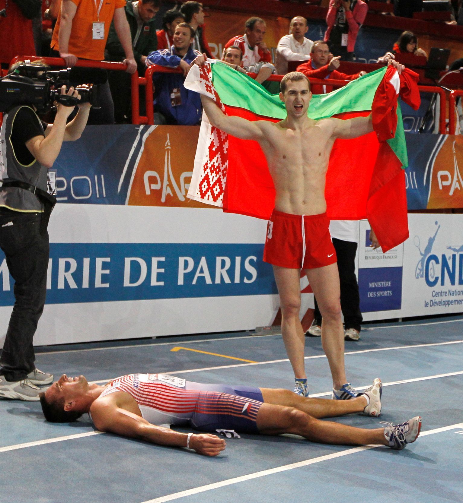 FILE PHOTO: Belarus's Krauchanka and Czech Republic's Sebrle react after the men's Heptathlon event at the European Athletics indoor championships in Paris
