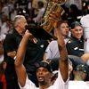 Miami Heat's Bosh raises the Larry O'Brien Championship Trop