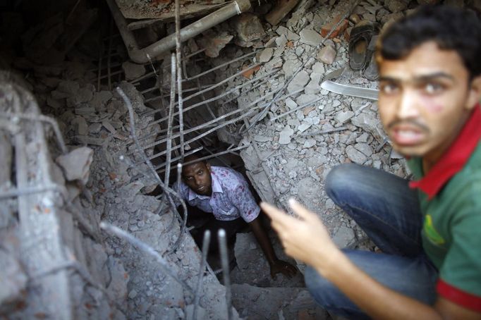 Rescue workers try to rescue trapped garment workers in the Rana Plaza building which collapsed, in Savar, 30 km (19 miles) outside Dhaka April 24, 2013. A block housing garment factories and shops collapsed in Bangladesh on Wednesday, killing nearly 100 people and injuring more than a thousand, officials said.REUTERS/Andrew Biraj (BANGLADESH - Tags: DISASTER BUSINESS) Published: Dub. 24, 2013, 3:45 odp.