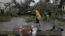 A man walks near a damaged power line in Santiago de Cuba October 25, 2012. Hurricane Sandy grew into a major potential threat to the east coast of the United States on Thursday after hammering Cuba's second-largest city and taking aim at the Bahamas, U.S. forecasters said. Strengthening rapidly after tearing into Jamaica and crossing the warm Caribbean Sea, Sandy hit southeastern Cuba early on Thursday with 105-mph winds that cut power and blew over trees across the city of Santiago de Cuba. Reports from the city of 500,000 people, about 470 miles (750 km) southeast of Havana spoke of significant damage, with many homes damaged or destroyed. According to one Cuban radio report, at least one person was killed, bringing the death toll to at least three after fatalities in Jamaica and Haiti. REUTERS/Miguel Rubiera/Cuban Government National Information Agency - AIN/Handout (CUBA - Tags: ENVIRONMENT DISASTER) FOR EDITORIAL USE ONLY. NOT FOR SALE FOR MARKETING OR ADVERTISING CAMPAIGNS. THIS IMAGE HAS BEEN SUPPLIED BY A THIRD PARTY. IT IS DISTRIBUTED, EXACTLY AS RECEIVED BY REUTERS, AS A SERVICE TO CLIENTS Published: Říj. 25, 2012, 6:02 odp.