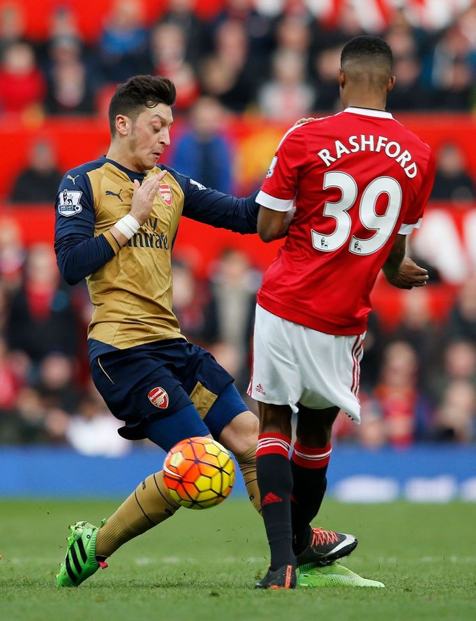 Manchester United's Marcus Rashford and Arsenal's Mesut Ozil