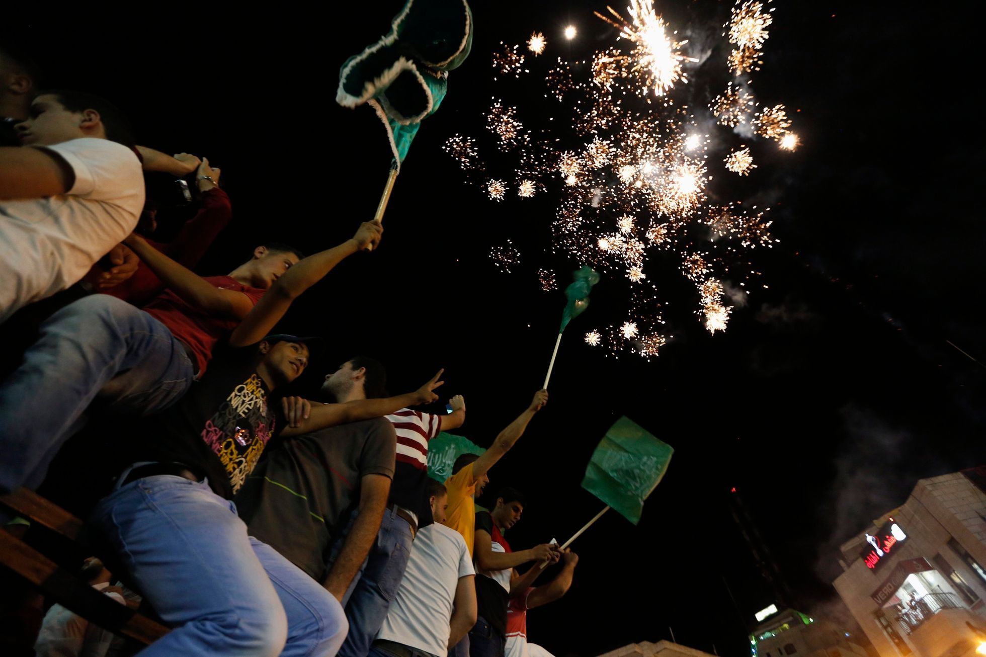Palestinians release fireworks as they celebrate what they said was a victory by Palestinians in Gaza over Israel following a ceasefire, in the West Bank city of Ramallah